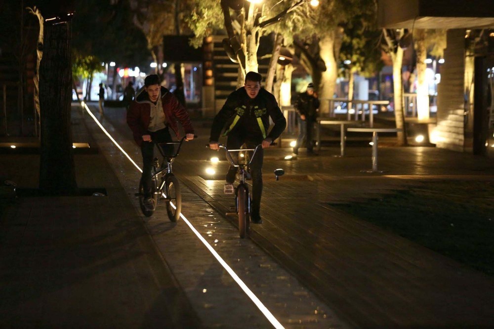 14-HAMAMYOLU URBAN DECK-bicycle riders finding their way on led light beam axis.jpg